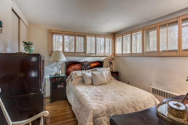 9 Wheeler Road Lexington, MA 02420 - Photo 23 of 30 a bedroom with a bed and wooden floor