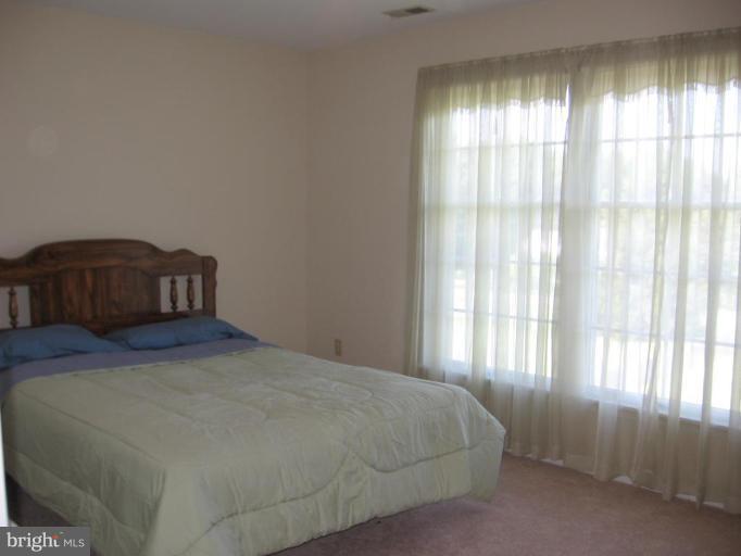 4325 Dunn Road Huntingtown, MD 20639 - Photo 21 of 23 a bedroom with a bed and a window