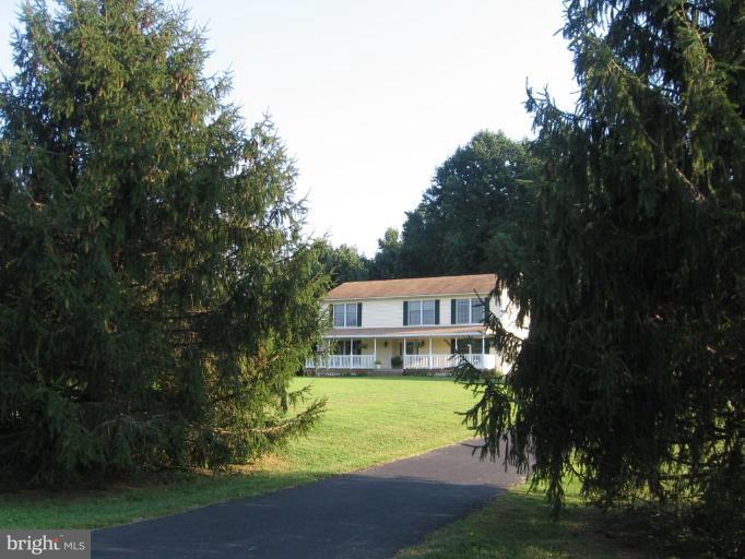 4325 Dunn Road Huntingtown, MD 20639 - Photo 5 of 23 a yellow and red building with trees in the background