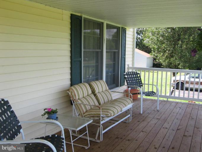 4325 Dunn Road Huntingtown, MD 20639 - Photo 7 of 23 a outdoor living space with furniture