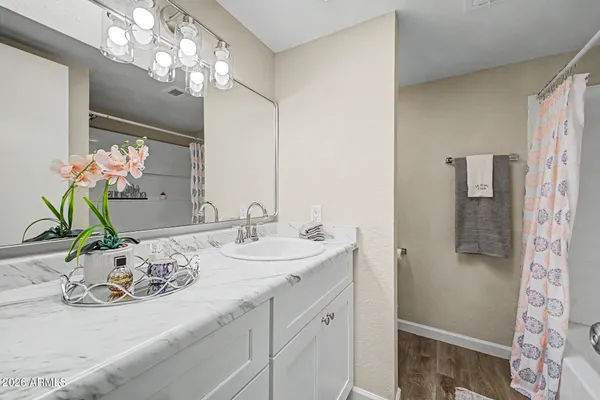 a bathroom with a bath tub with a shower