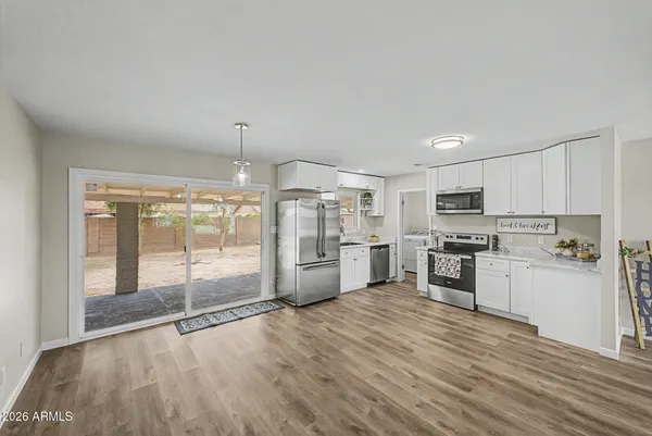 a kitchen with stainless steel appliances a refrigerator sink and stove