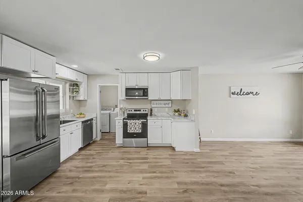a kitchen with stainless steel appliances a stove a sink and a microwave