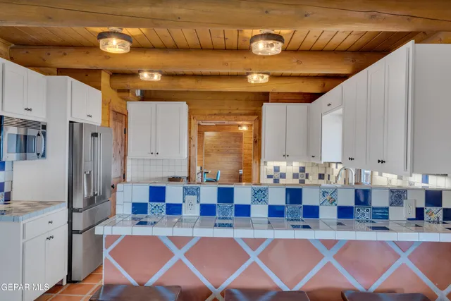 a living room with fireplace furniture and a rug