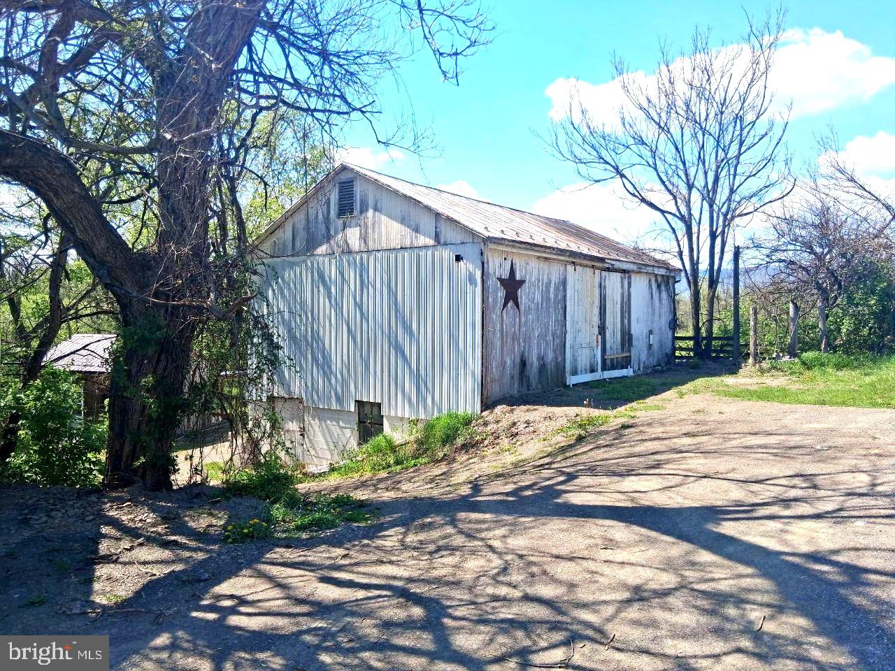 122 Shippensburg Road Newburg, PA 17240 - Photo 3 of 76 Rustic barn under a bright sky.