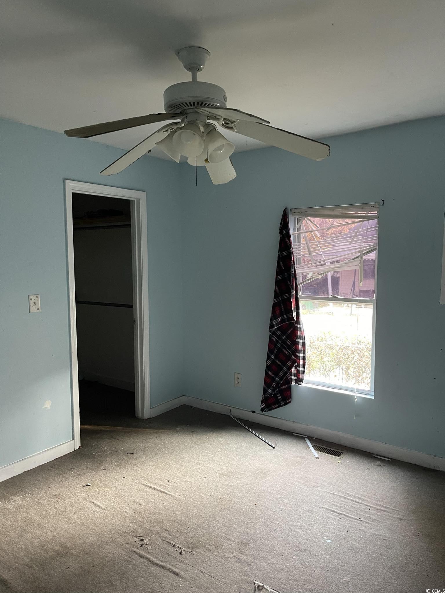1353 Moss Street Georgetown, SC 29440 - Photo 11 of 32 Empty room featuring ceiling fan and carpet