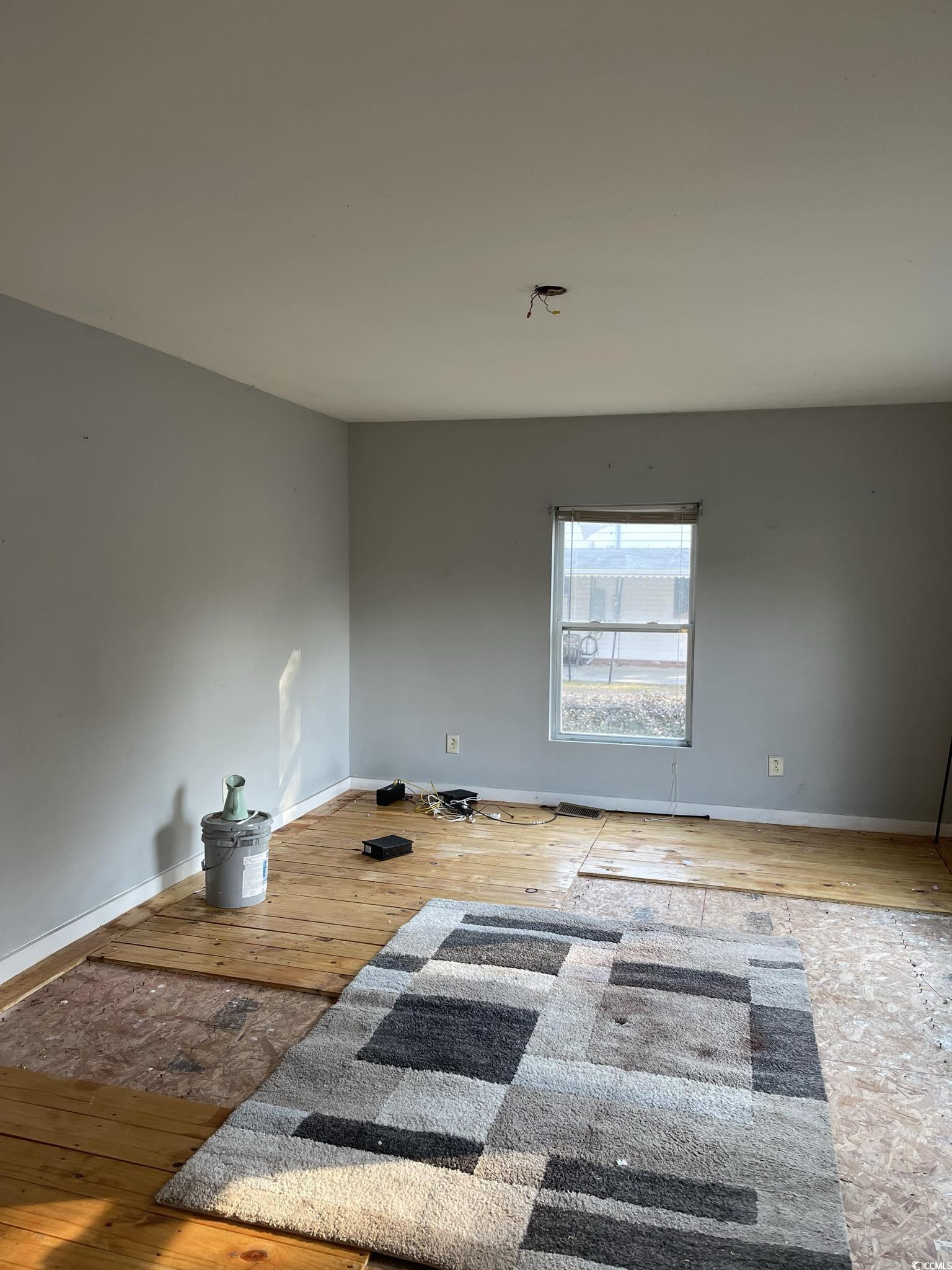 1353 Moss Street Georgetown, SC 29440 - Photo 13 of 32 Spare room featuring wood-type flooring