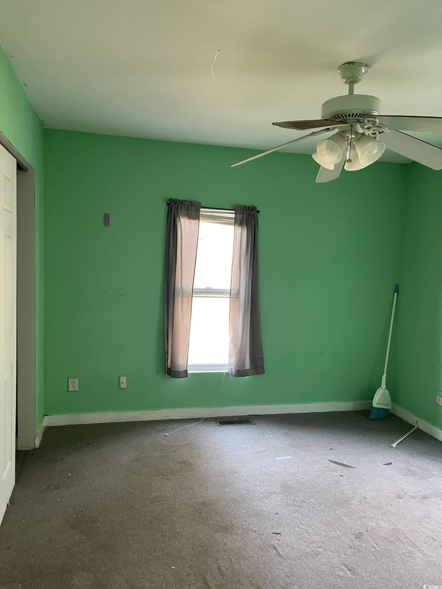 1353 Moss Street Georgetown, SC 29440 - Photo 14 of 32 Carpeted empty room with ceiling fan
