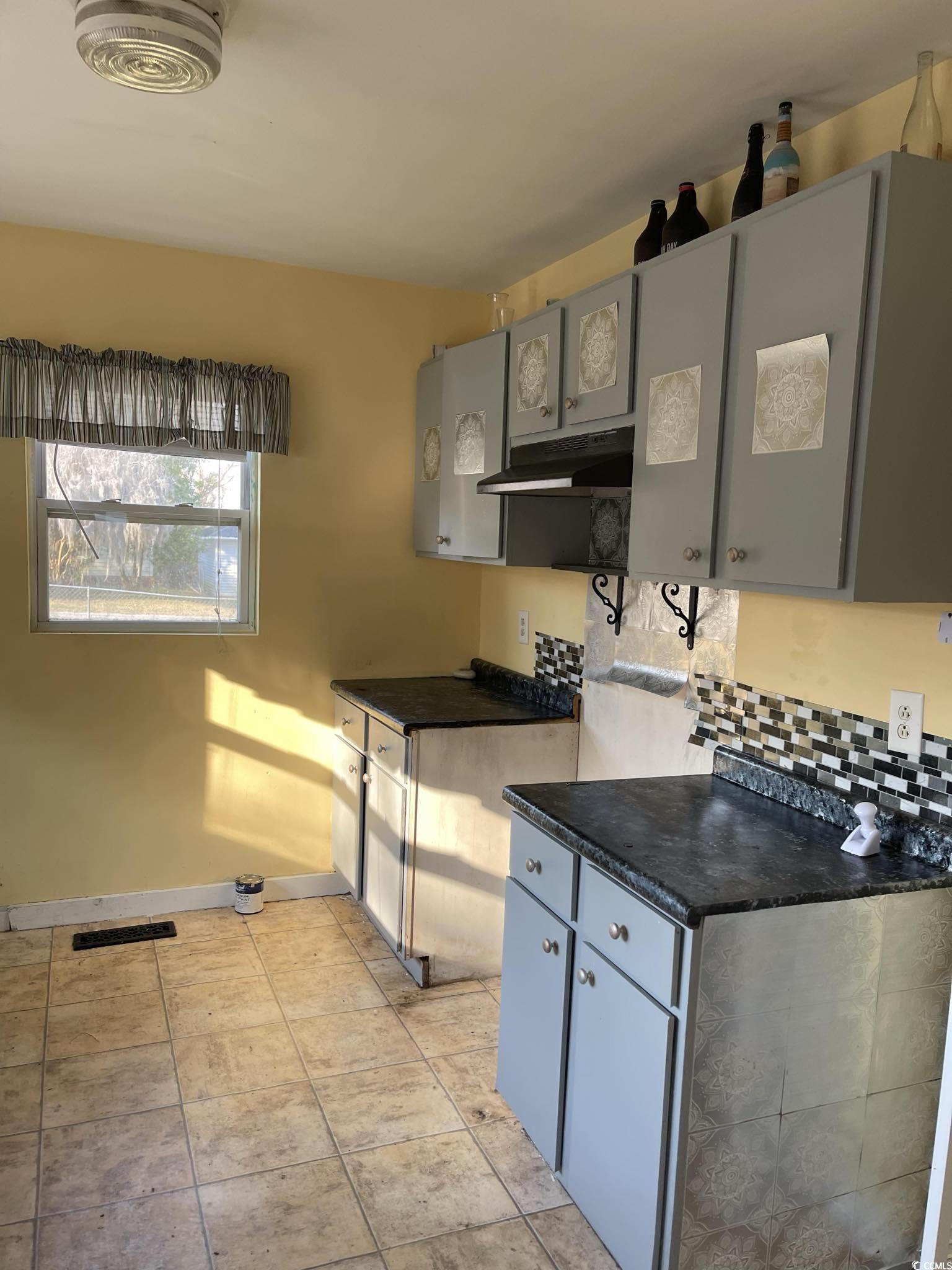 1353 Moss Street Georgetown, SC 29440 - Photo 25 of 32 Kitchen with tasteful backsplash, gray cabinets, a