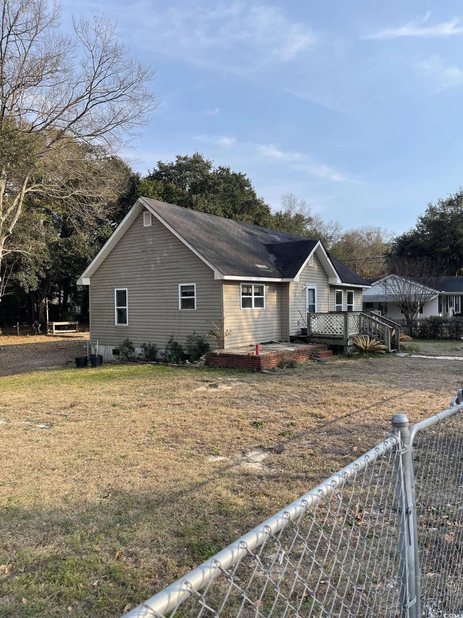 1353 Moss Street Georgetown, SC 29440 - Photo 3 of 32 View of home's exterior with a wooden deck and a y