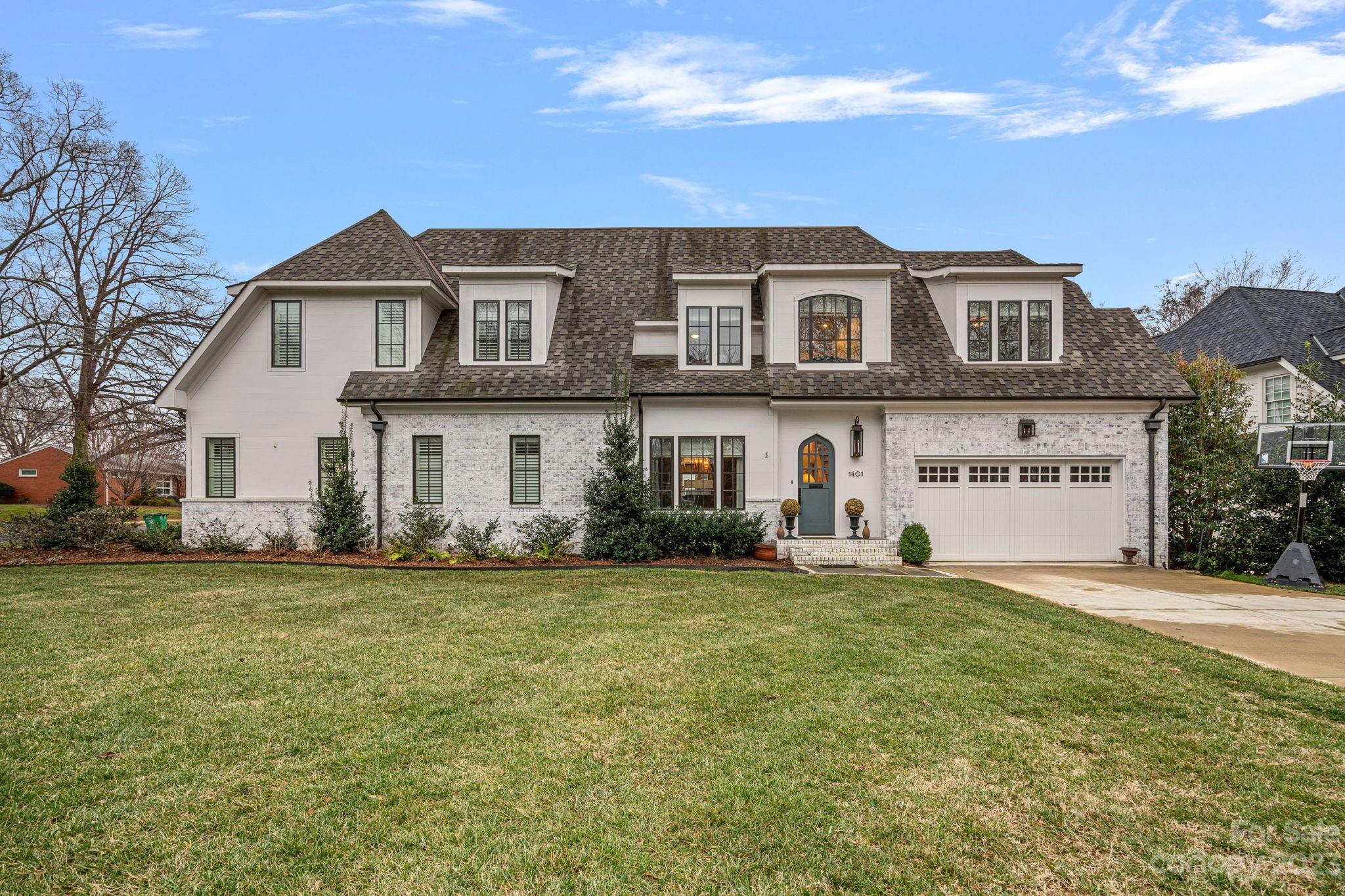 a front view of a house with a garden
