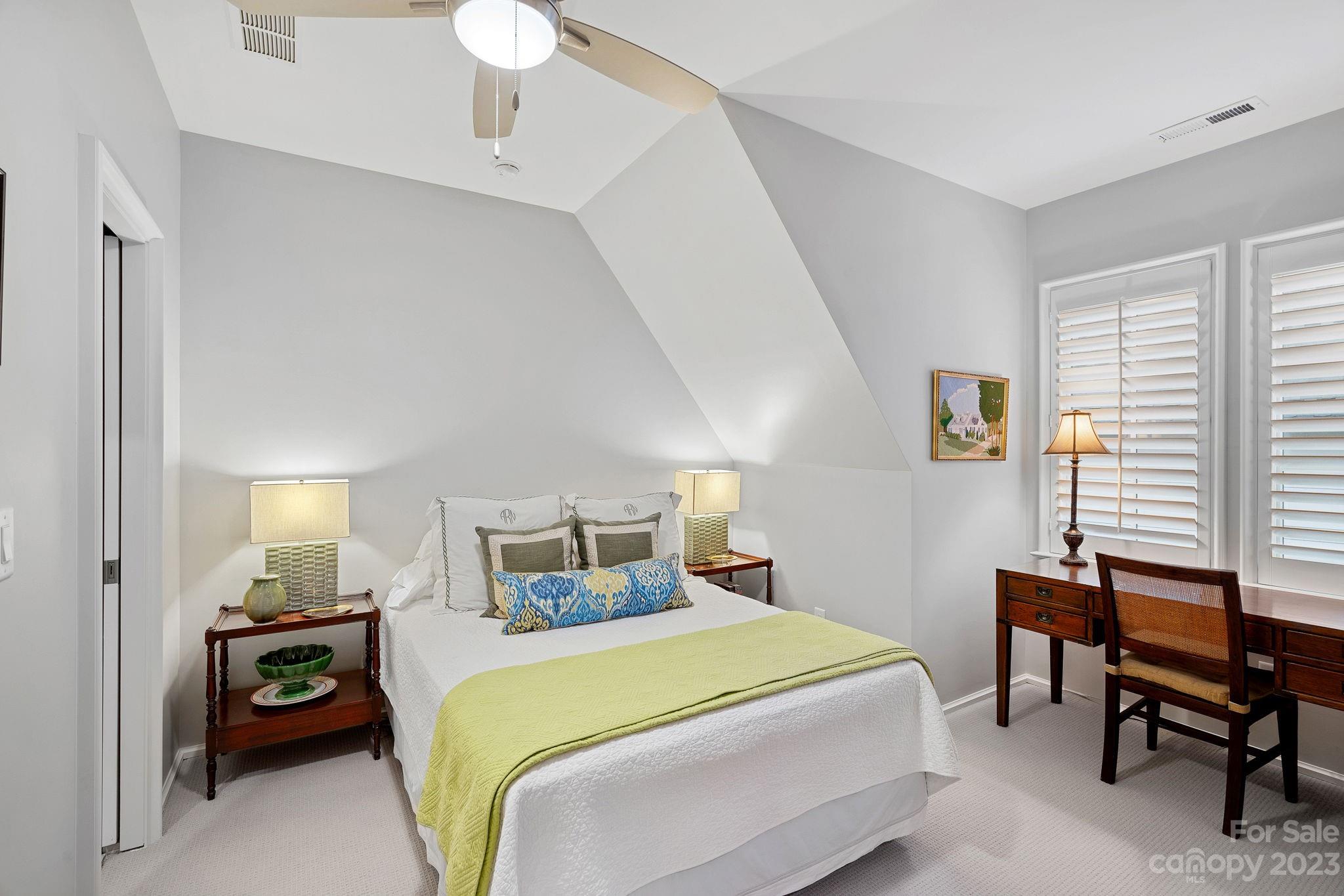 1401 Audubon Road Charlotte, NC 28211 - Photo 22 of 39 a bedroom with a bed and a chandelier