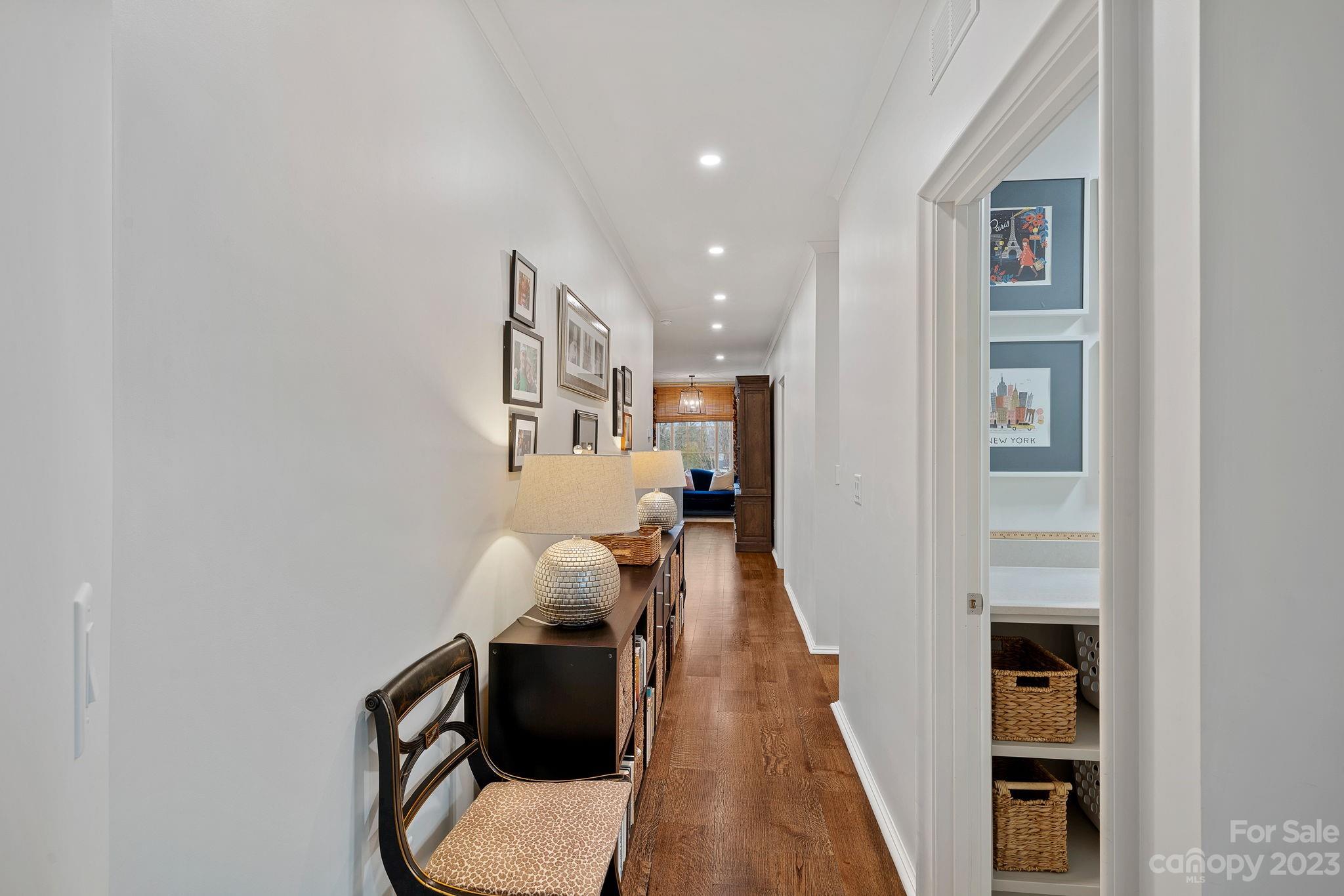 1401 Audubon Road Charlotte, NC 28211 - Photo 31 of 39 a hallway with painting on the wall and a wooden floor