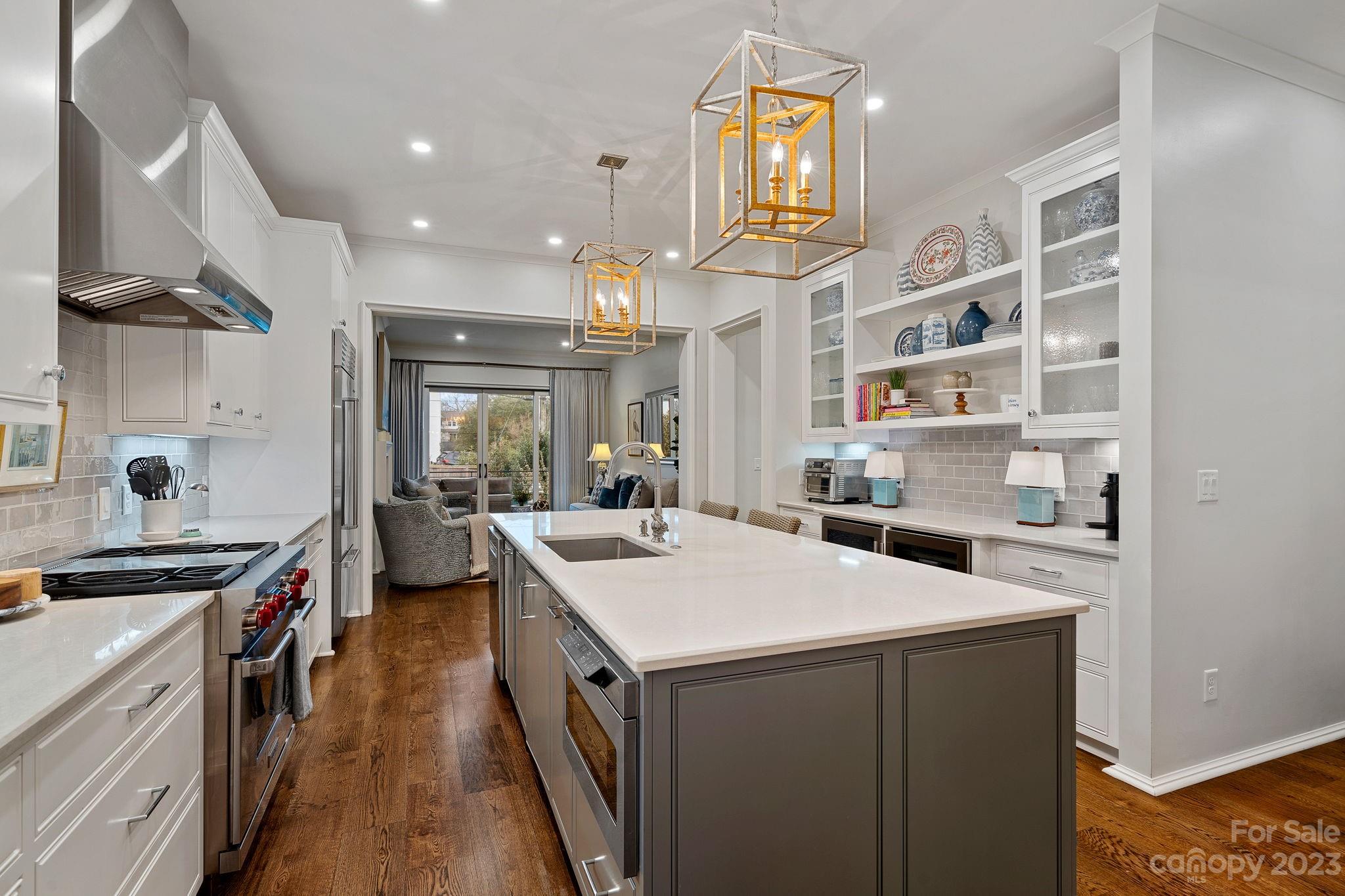 1401 Audubon Road Charlotte, NC 28211 - Photo 8 of 39 a kitchen that has a sink a stove and a wooden floor