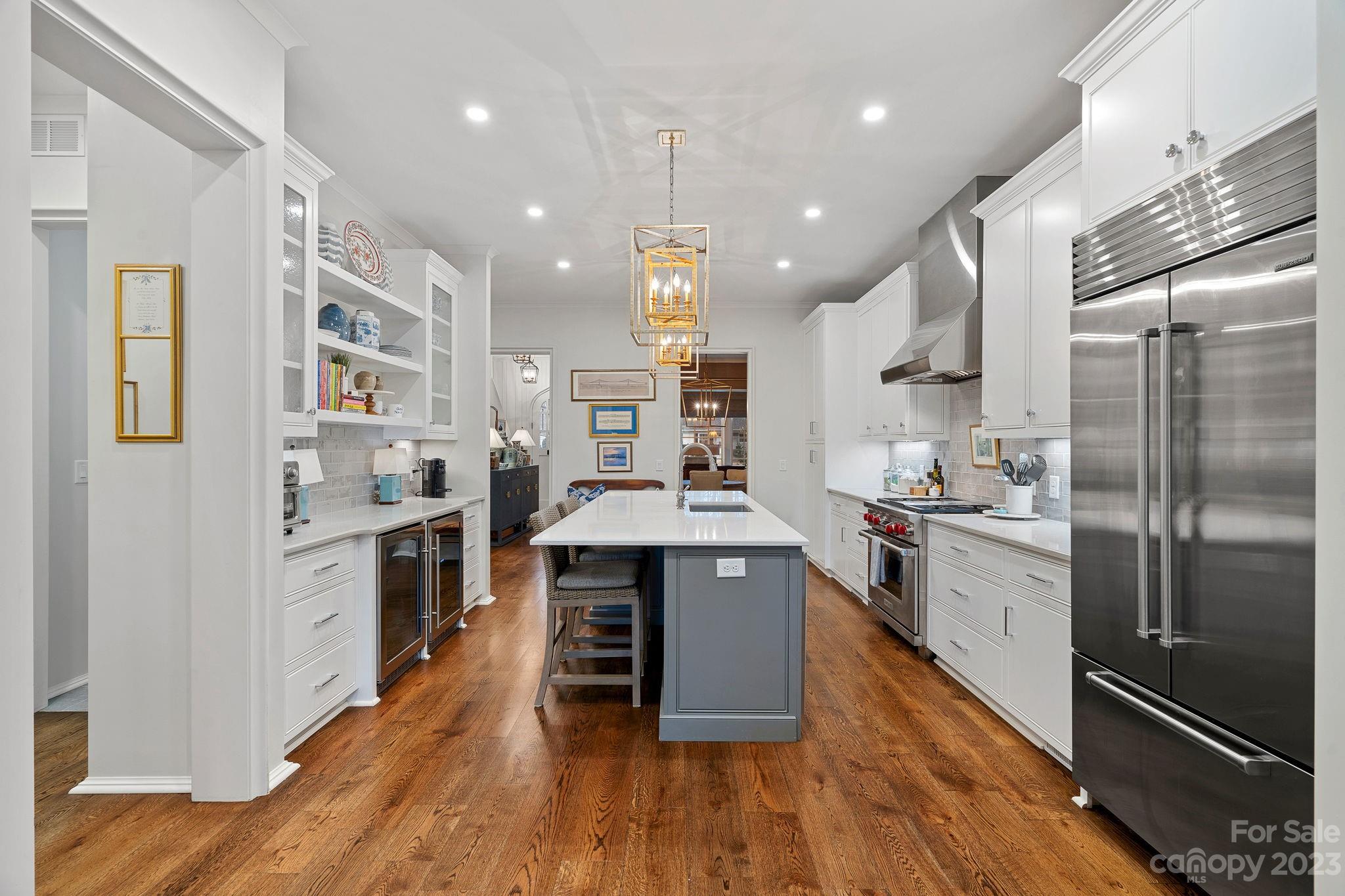 1401 Audubon Road Charlotte, NC 28211 - Photo 9 of 39 a large kitchen with stainless steel appliances lots of counter space and wooden floor