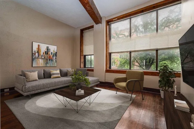 a living room with furniture and a large window