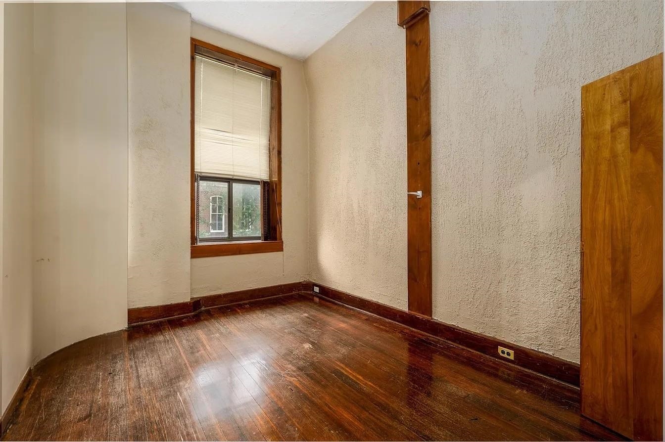 107 South Front Street, Unit 41 Memphis, TN 38103 - Photo 13 of 17 an empty room with wooden floor and windows