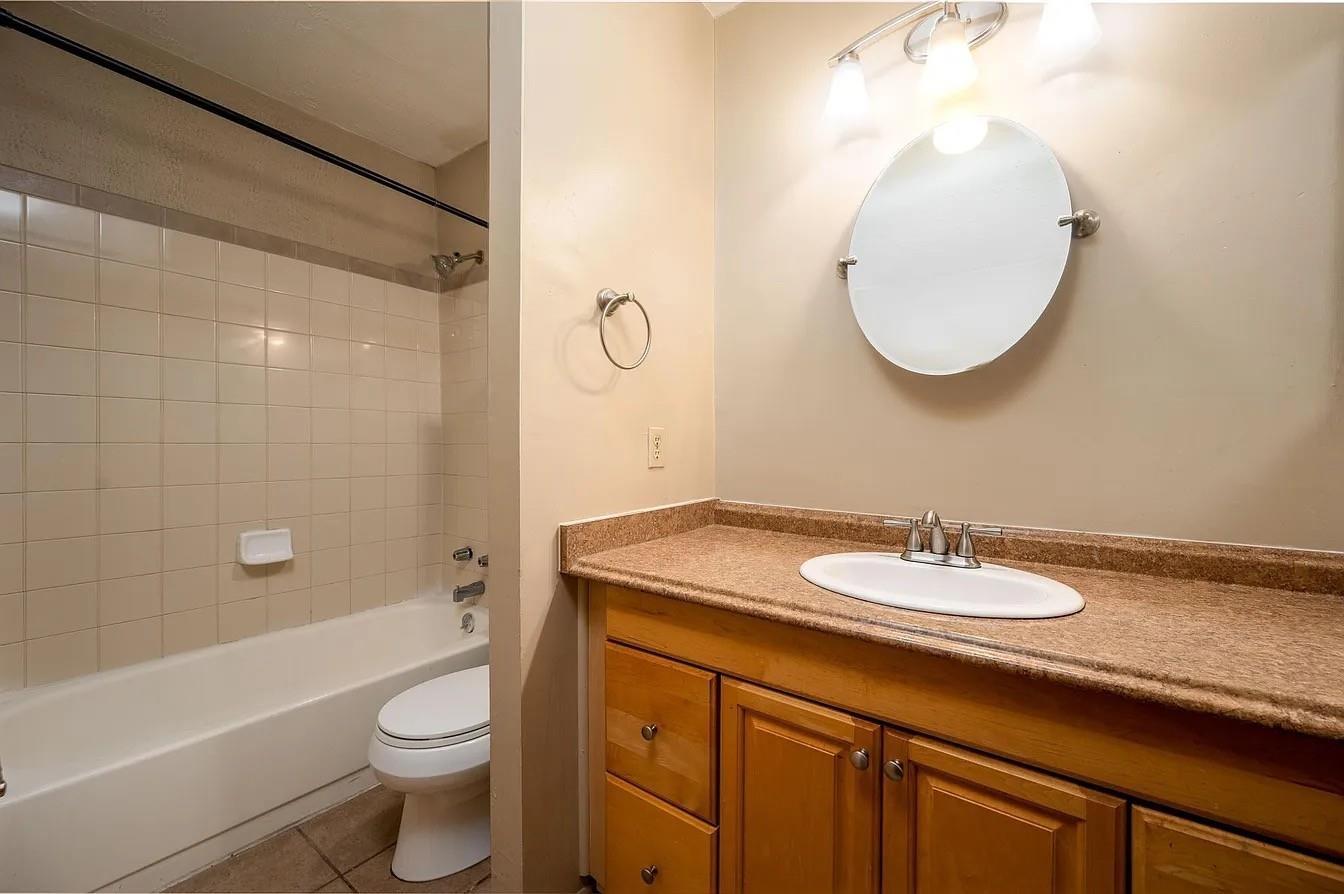 107 South Front Street, Unit 41 Memphis, TN 38103 - Photo 14 of 17 a bathroom with a granite countertop sink toilet a mirror and bathtub