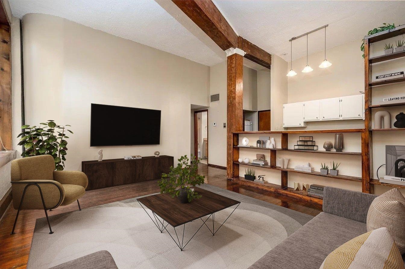 107 South Front Street, Unit 41 Memphis, TN 38103 - Photo 2 of 17 a living room with furniture and a flat screen tv