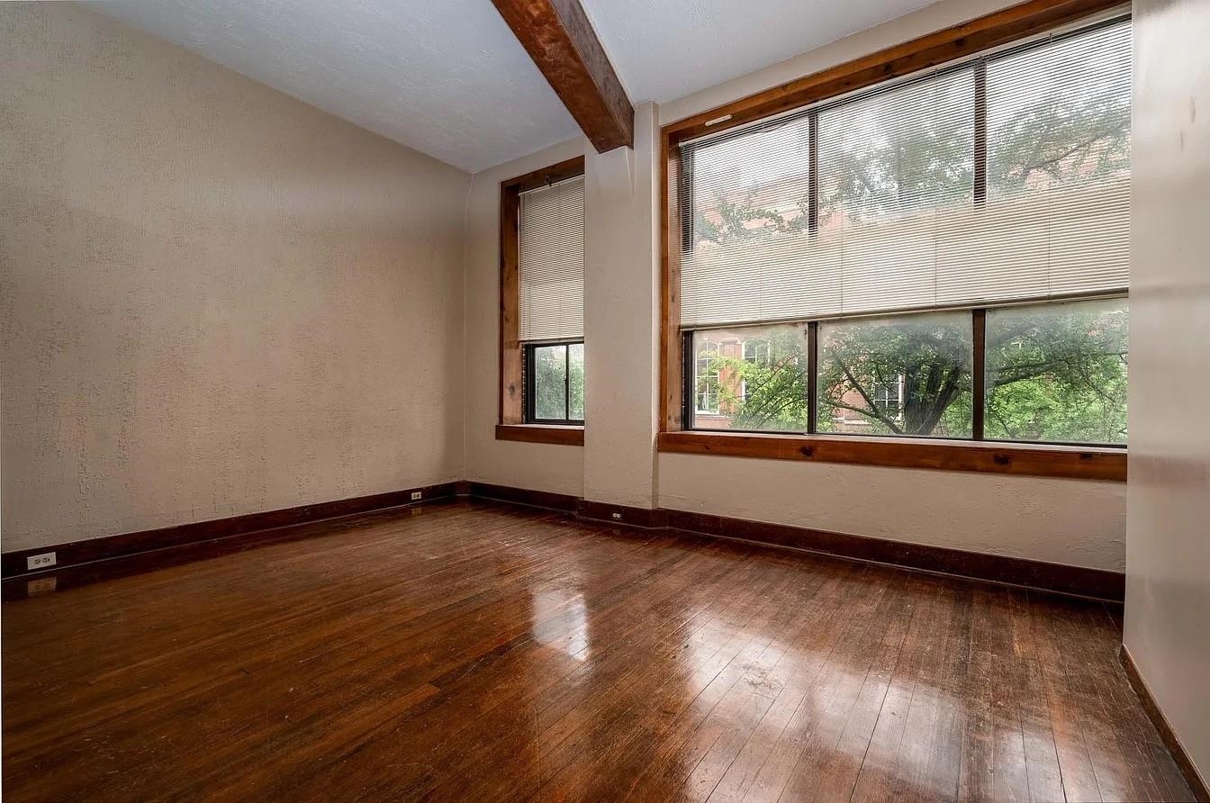 107 South Front Street, Unit 41 Memphis, TN 38103 - Photo 6 of 17 a view of an empty room with wooden floor and a window