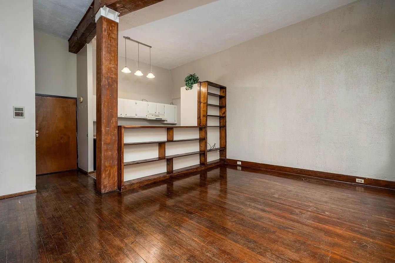 107 South Front Street, Unit 41 Memphis, TN 38103 - Photo 8 of 17 a view of an empty room with wooden floor and a window