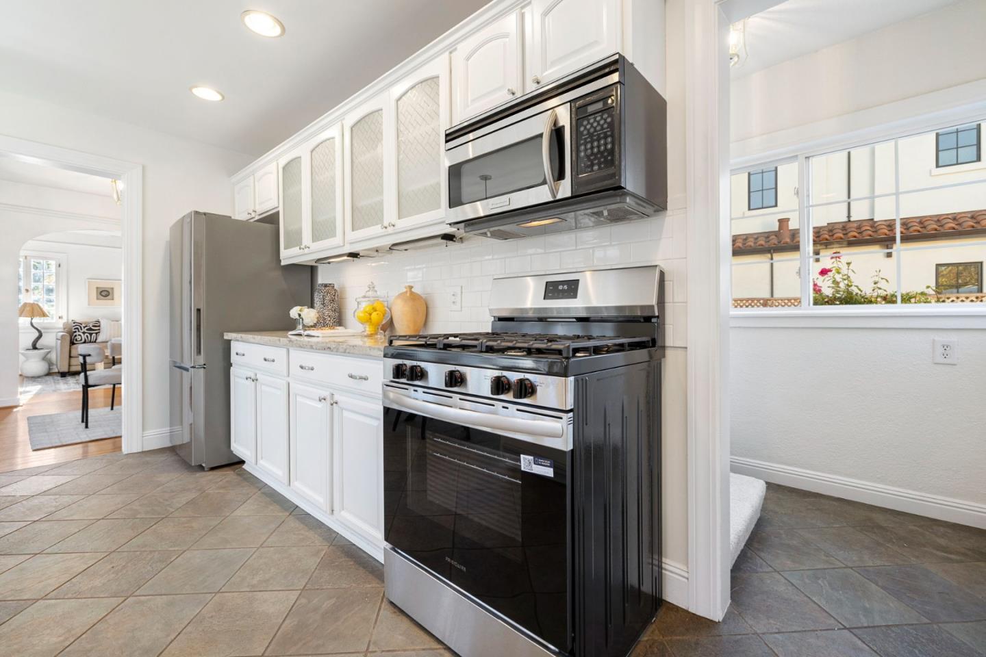 1030 Morrell Avenue Burlingame, CA 94010 - Photo 16 of 37 a kitchen with stainless steel appliances granite countertop a stove microwave and cabinets