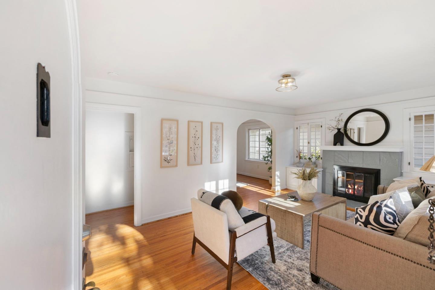 1030 Morrell Avenue Burlingame, CA 94010 - Photo 6 of 37 a living room with furniture a fireplace and a potted plant