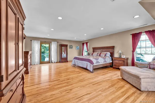 a view of empty room with wooden floor and entryway