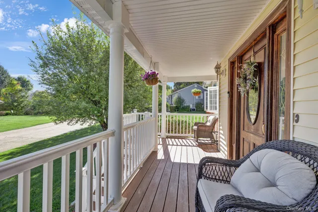 a view of a two chairs in the balcony