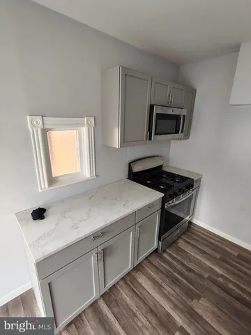 a kitchen with a sink and a stove top oven