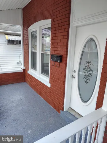 a view of a door with brick walls