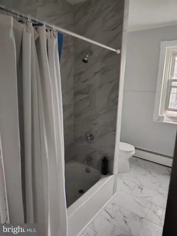 a bathroom with a shower and a toilet