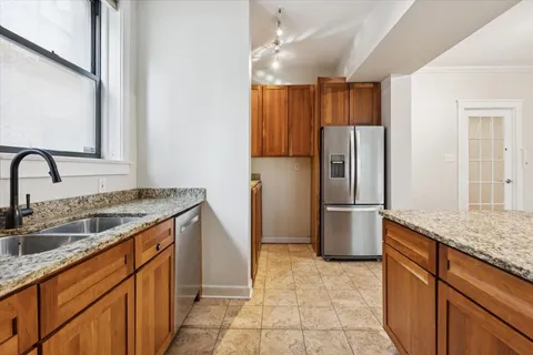 a kitchen with stainless steel appliances granite countertop a refrigerator and a sink