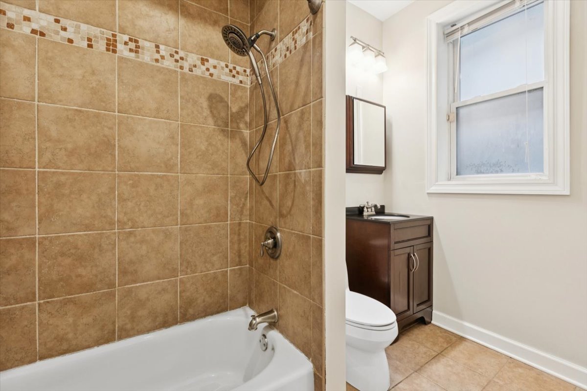 5118 South Ingleside Avenue, Unit A Chicago, IL 60615 - Photo 7 of 16 a bathroom with a toilet and a shower