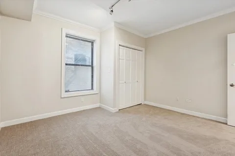 an empty room with windows and closet