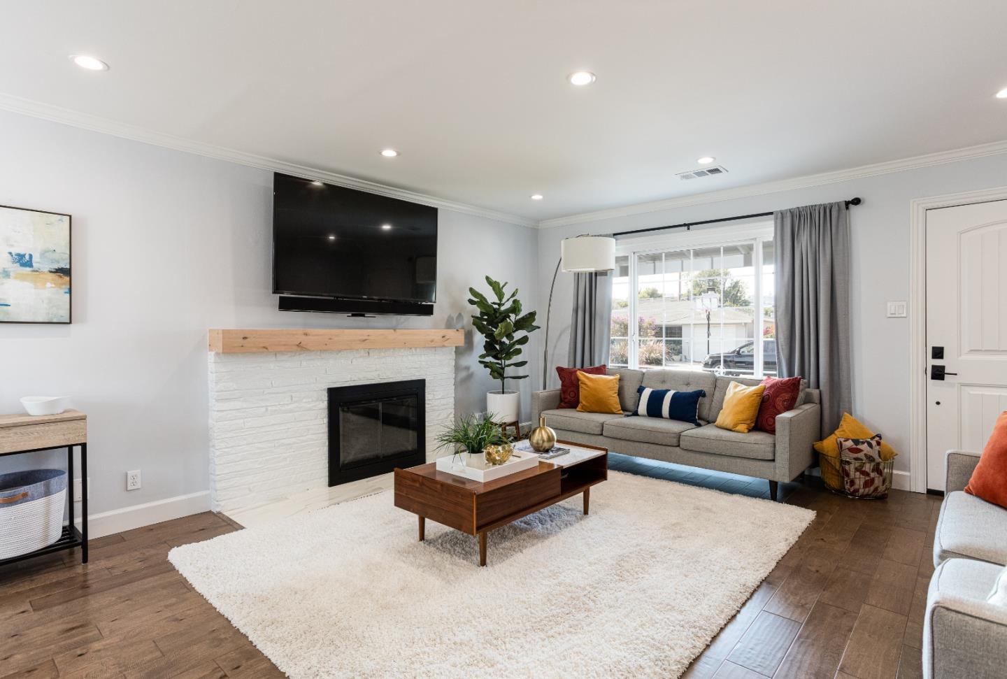 3961 Casanova Drive San Mateo, CA 94403 - Photo 4 of 14 a living room with furniture a fireplace and a flat screen tv