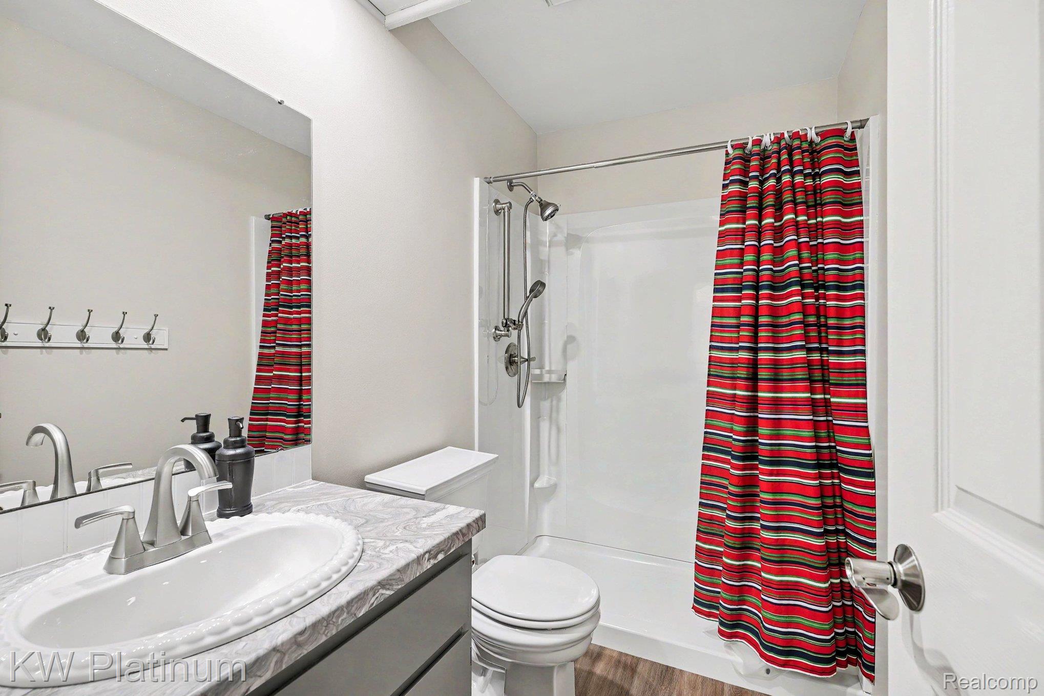 1700 River Road, Unit 6 Marysville, MI 48040 - Photo 21 of 32 Bathroom featuring a vanity with an undermount sink, brushed nickel faucet, and gray countertop