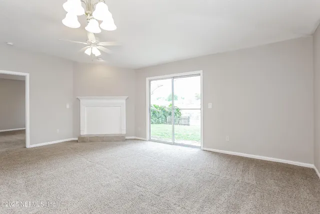 a kitchen with stainless steel appliances granite countertop a sink a stove and white cabinets with wooden floor