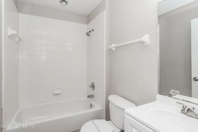 an empty room with closet and a chandelier fan