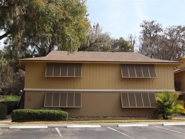 a view of ocean with boats and trees in the background