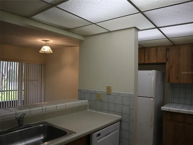 a kitchen with a sink and a refrigerator