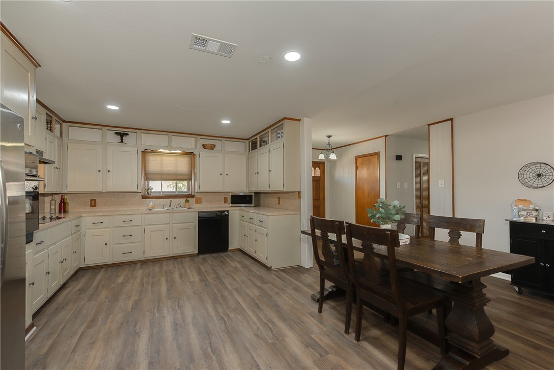 2106 Barak Lane Bryan, TX 77802 - Photo 11 of 27 a large kitchen with a table and chairs
