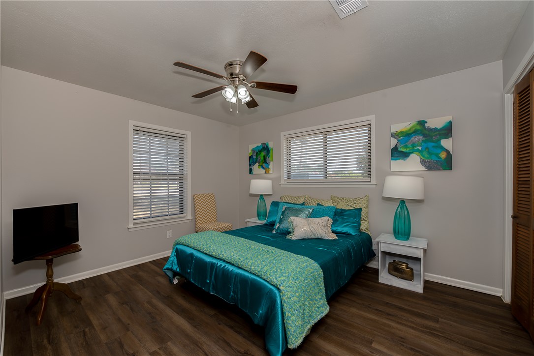 2106 Barak Lane Bryan, TX 77802 - Photo 15 of 27 a bedroom with a bed a window and a flat screen tv