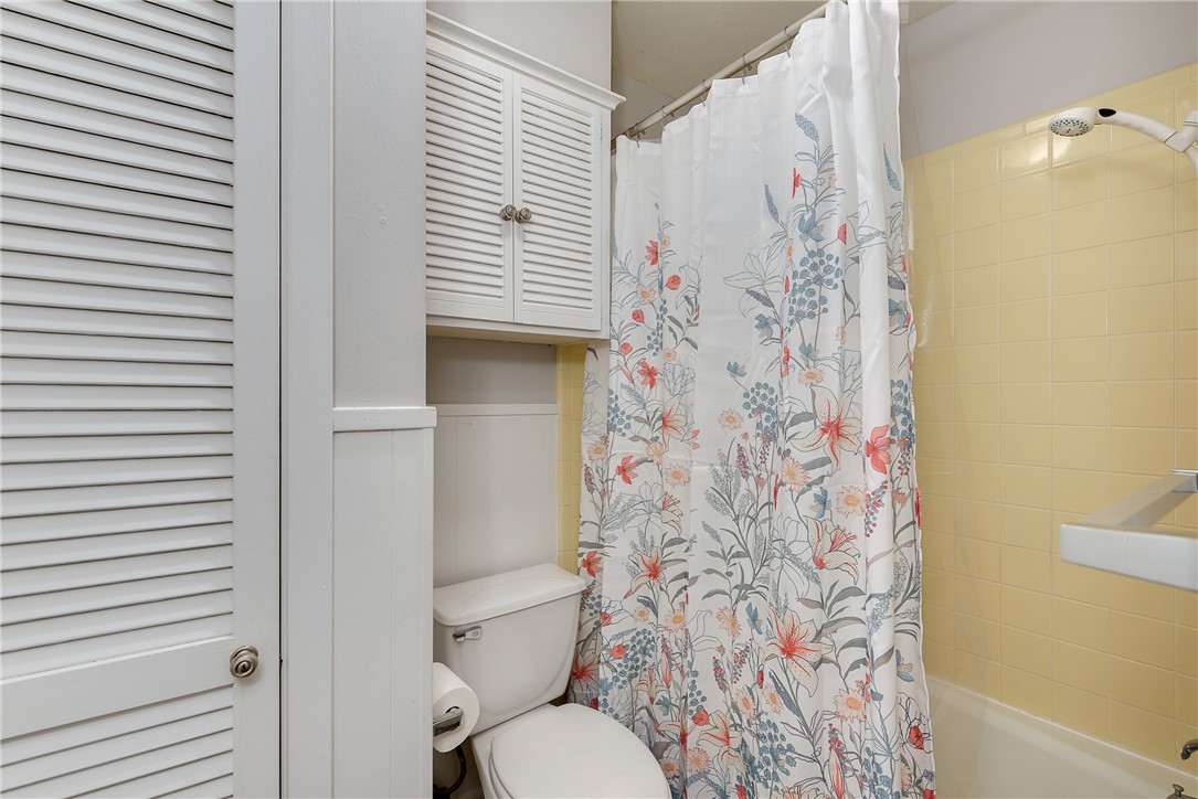 2106 Barak Lane Bryan, TX 77802 - Photo 18 of 27 a bathroom with a toilet and shower curtain