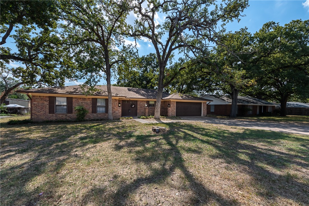 2106 Barak Lane Bryan, TX 77802 - Photo 2 of 27 a large tree in front of a house