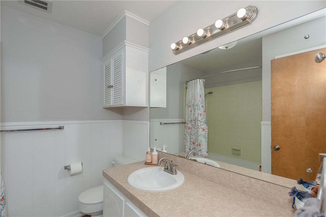2106 Barak Lane Bryan, TX 77802 - Photo 21 of 27 a bathroom with a granite countertop sink a toilet and a mirror