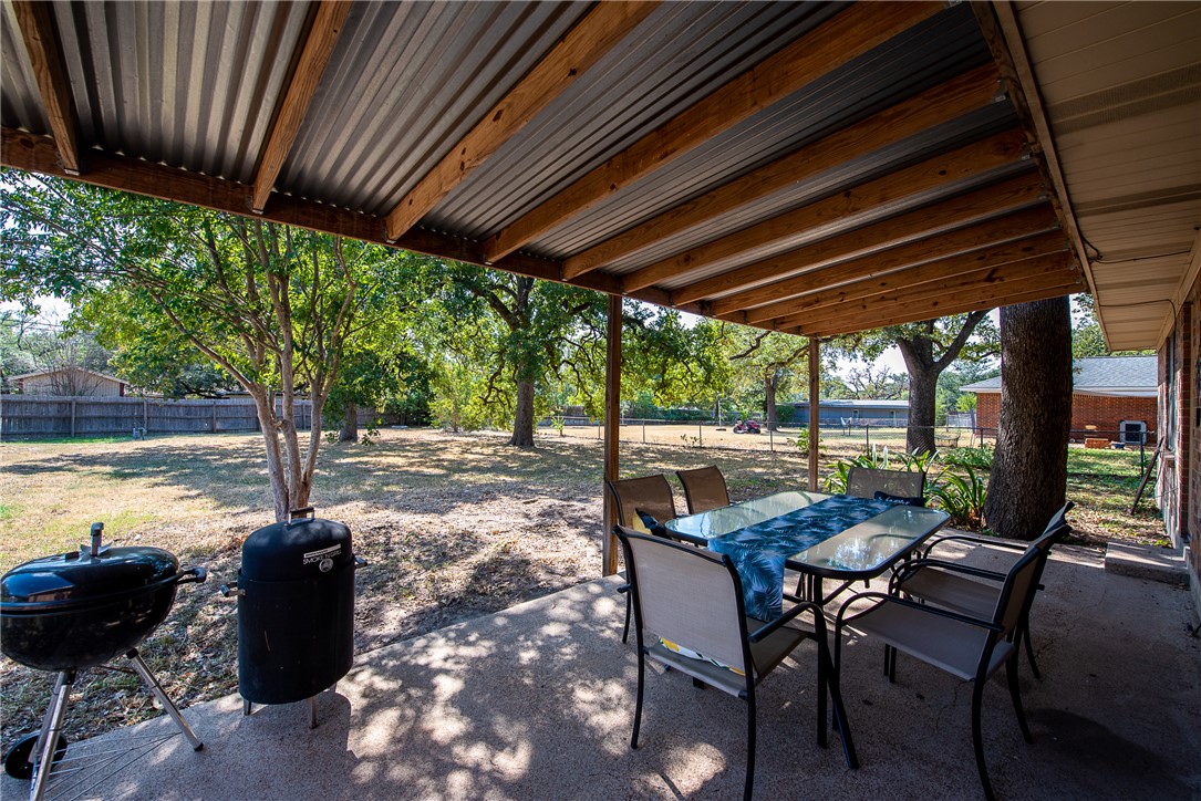 2106 Barak Lane Bryan, TX 77802 - Photo 24 of 27 a view of a patio with a table chairs and a backyard