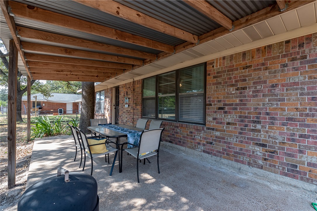 2106 Barak Lane Bryan, TX 77802 - Photo 25 of 27 a patio with table and chairs and potted plants
