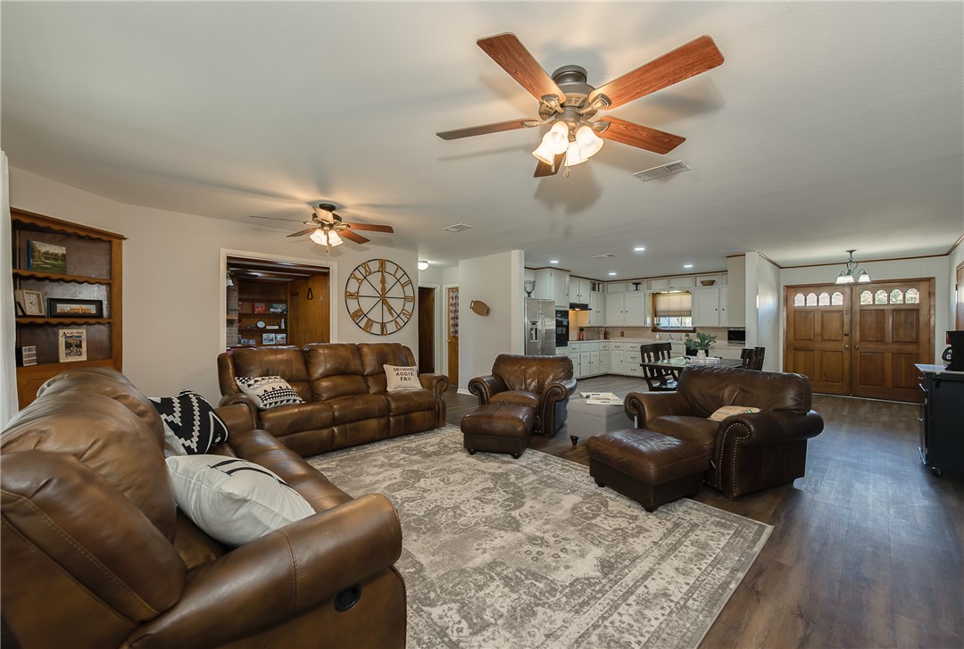 2106 Barak Lane Bryan, TX 77802 - Photo 4 of 27 a living room with furniture a ceiling fan and a rug