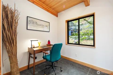 a view of a livingroom with furniture and a window